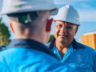 Image of two men speaking outside