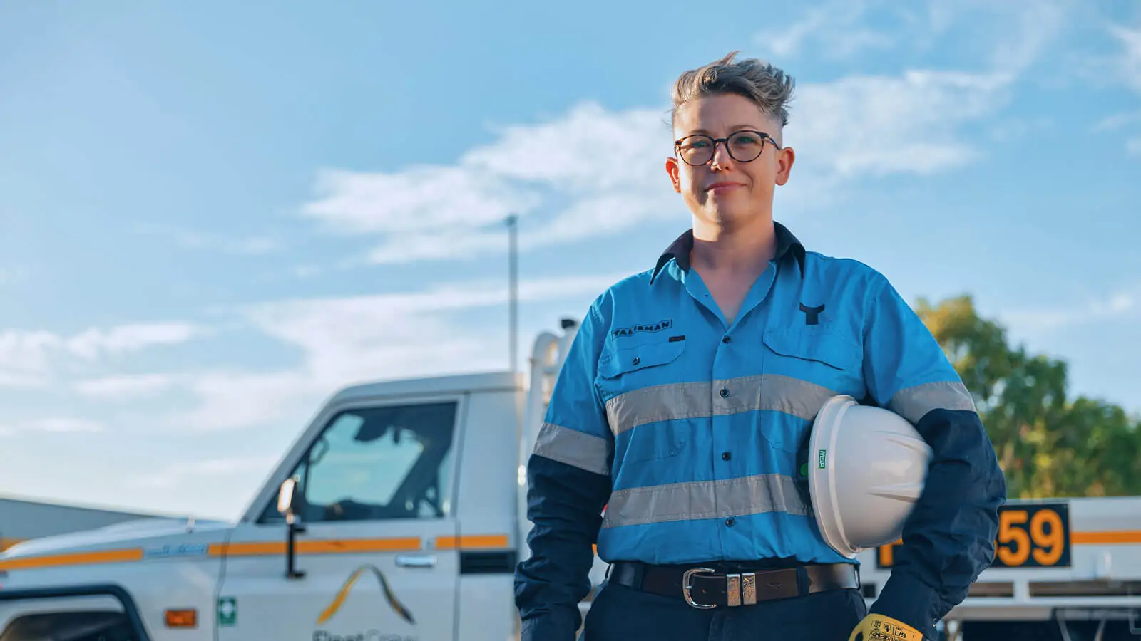Image of women smiling in front of a ute