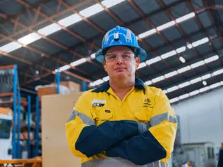Image of a man inside an industrial shed with safety equipment
